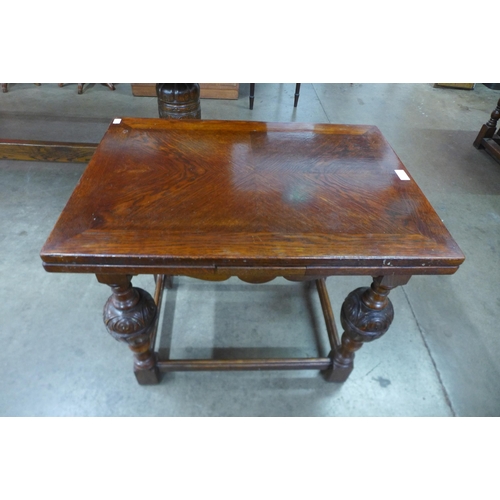 5 - A 17th Century style carved oak dwarf sized draw-leaf table, 60cms h, 70cms l, 50cms w