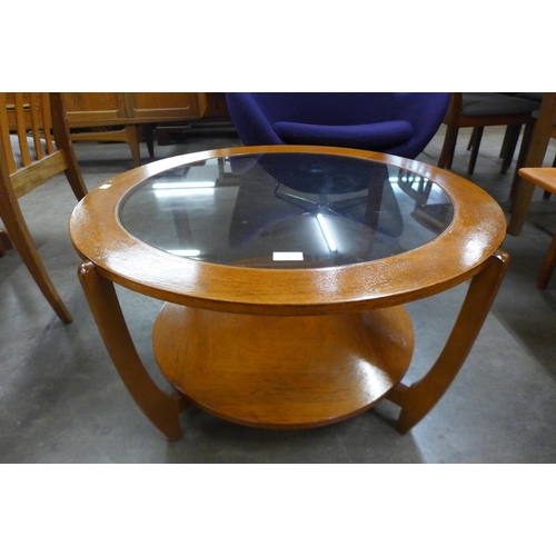 57 - A circular teak and glass topped coffee table