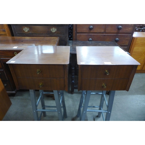 60 - A pair of afromosia two drawer chests on metal stands