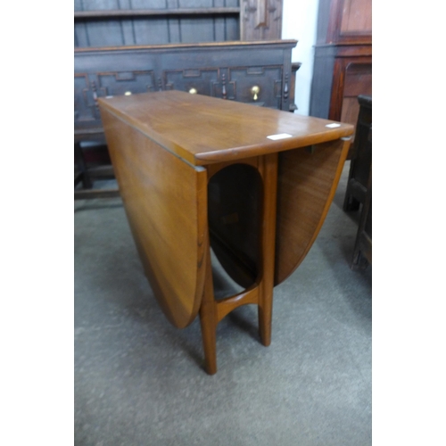 63 - A teak drop-leaf table