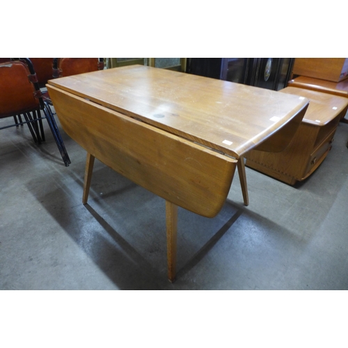 83 - An Ercol Blonde elm and beech drop-leaf table