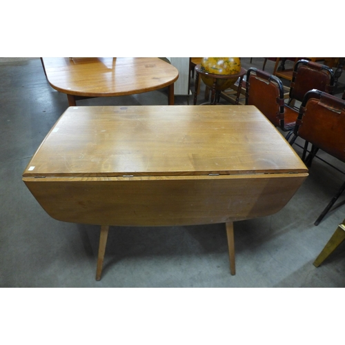 83 - An Ercol Blonde elm and beech drop-leaf table