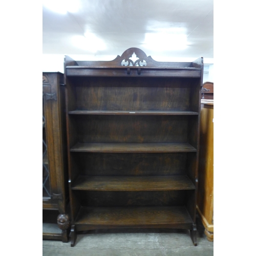 92 - An Arts and Crafts carved oak open bookcase