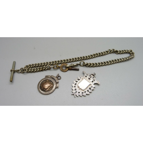 1060 - A metal Albert chain and two silver fobs