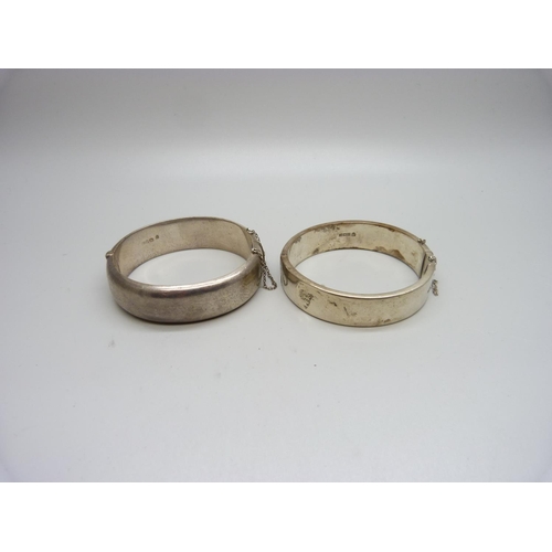 1062 - Two silver bangles, one with applied gold decoration, 54g, each dented