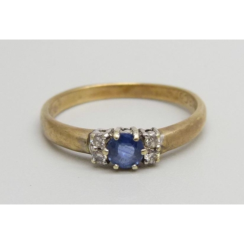 1069 - A 9ct gold, blue topaz and diamond ring, 1.9g, N