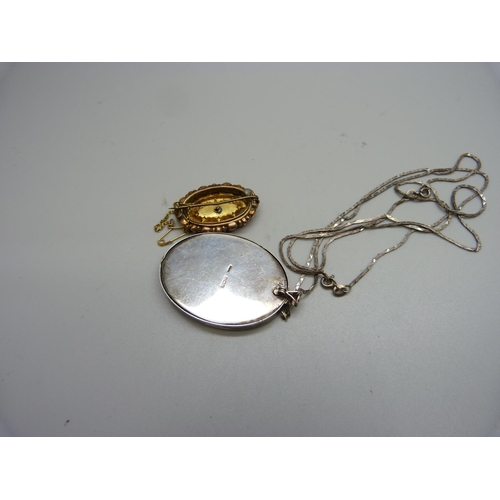 1087 - A Victorian 9ct gold, garnet and seed pearl set brooch, 4.1g, and a silver pendant and chain