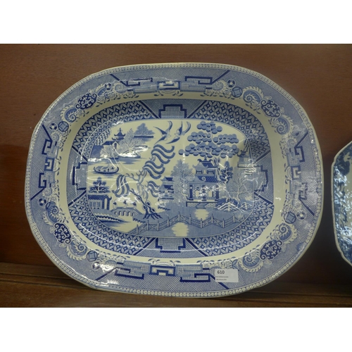 610 - An oriental blue and white plate, chip to the rim and  large blue and white Willow pattern meat plat... 