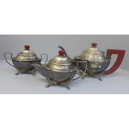 634 - A plated three piece tea service with red Bakelite or phenolic finials and handle