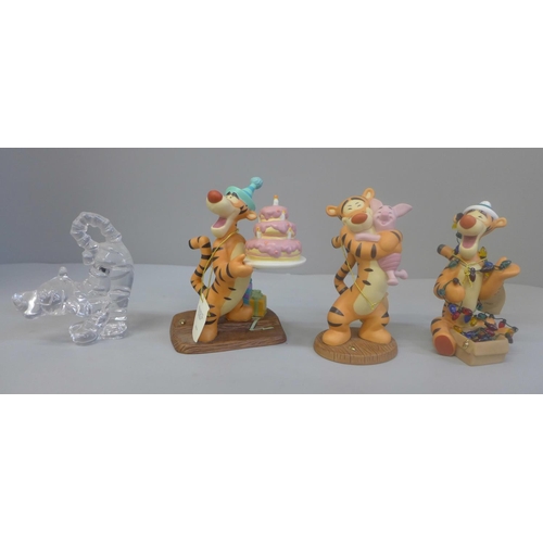 655 - A Disney glass Tigger figure and three Winnie The Pooh figures comprising Party Time Is Tigger Time,... 