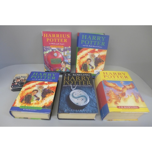 658 - Four Harry Potter books, first editions, one other in Latin and a set of playing cards