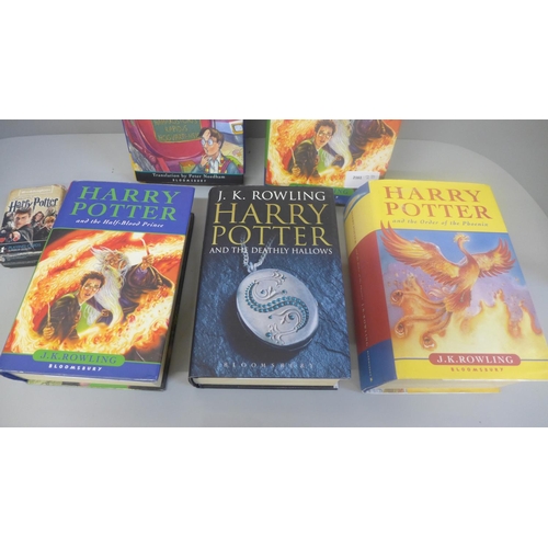 658 - Four Harry Potter books, first editions, one other in Latin and a set of playing cards