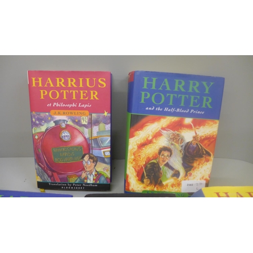 658 - Four Harry Potter books, first editions, one other in Latin and a set of playing cards