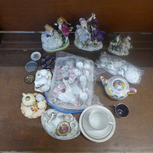 675 - Three continental figure groups and a collection of miniature tea sets