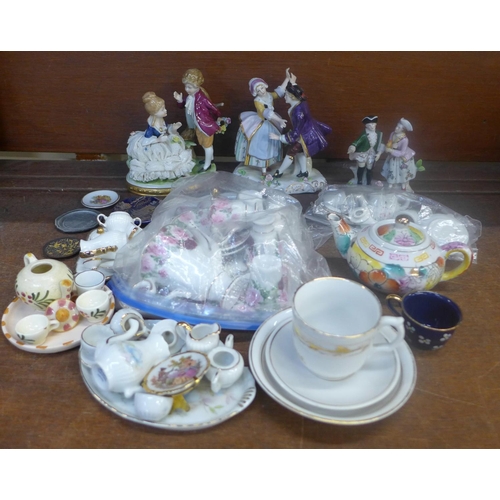 675 - Three continental figure groups and a collection of miniature tea sets