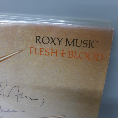 693 - A Roxy Music autographed LP record, Flesh and Blood signed by Brian Ferry, Andy Mackay and Phil Manz... 