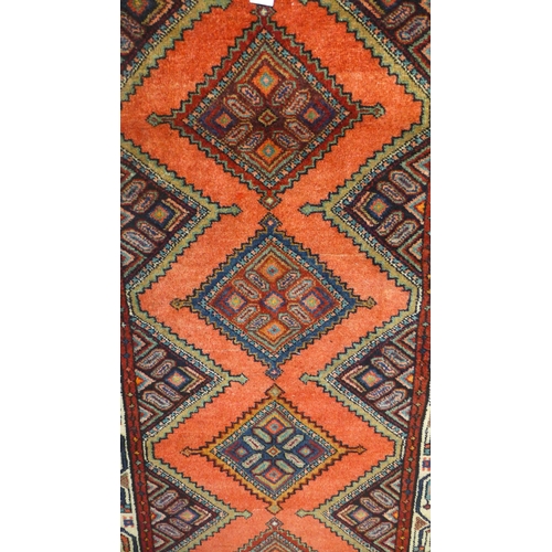 1619 - A washed red ground Persian Meshlin runner, with diamond medallion design 244cm x 99cm