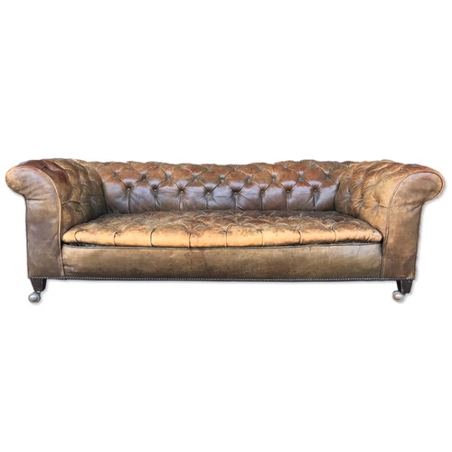 22 - A Victorian tan leather Chesterfield settee, 63cms h, 182cms w, 91cms d