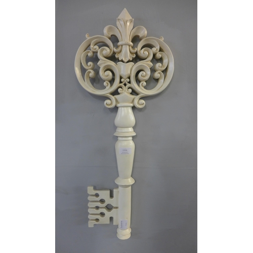 1336 - A large white ornamental key