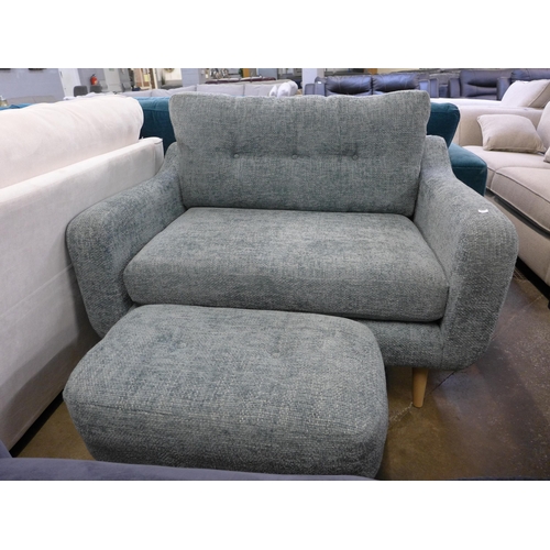 1534 - An aquamarine upholstered button back love seat with footstool