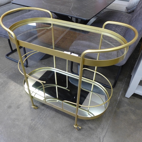 1564 - A gold mirrored drinks trolley