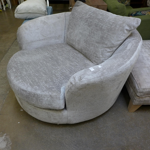 1568 - A pewter upholstered swivel love seat