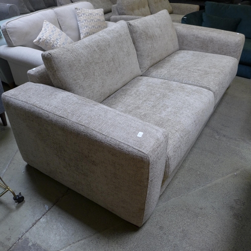 1583 - An oatmeal upholstered four seater sofa