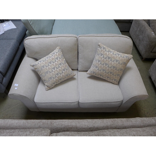 1584 - A sand upholstered two seater sofa