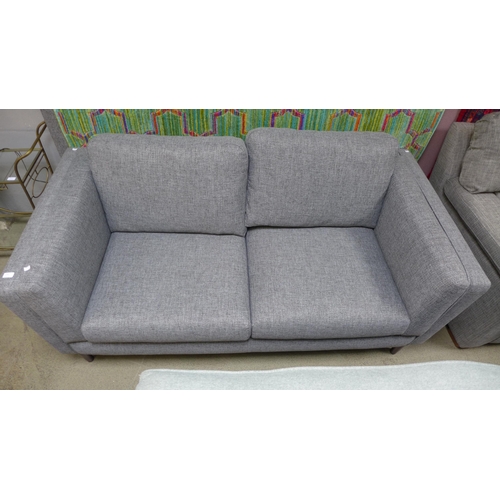 1585 - A stone grey upholstered three seater sofa