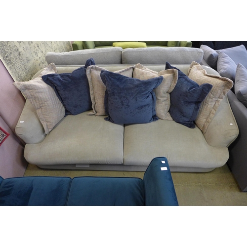 1604 - A cloud grey upholstered four seater sofa with scatter cushions (damaged feet)