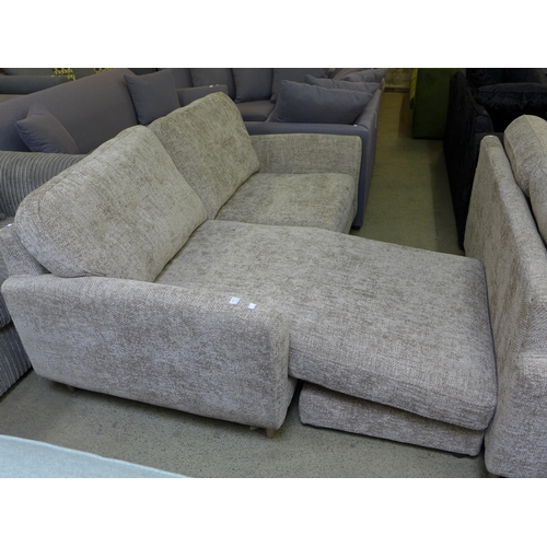 1610 - An oatmeal upholstered convertible three seater sofa/chaise