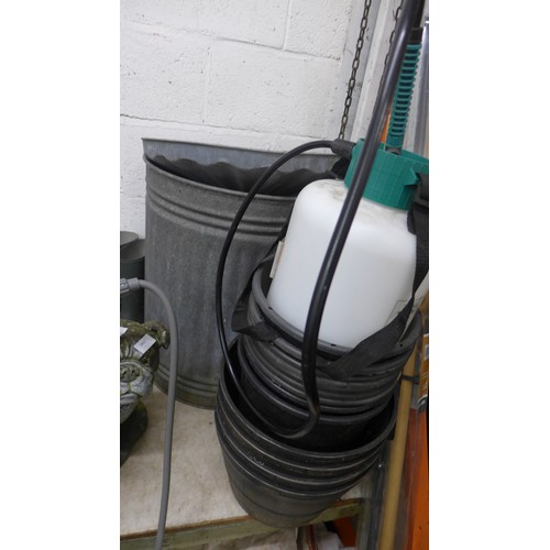 2492A - Galvanised steel dustbin with yellow hose on reel, planters and garden sprayer