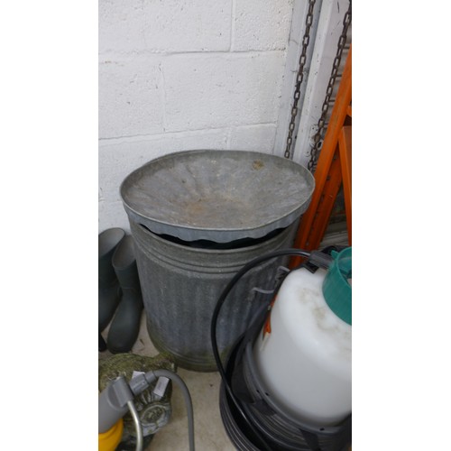 2492A - Galvanised steel dustbin with yellow hose on reel, planters and garden sprayer