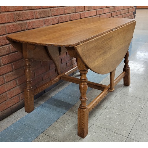 102A - A Nigel Griffiths carved oak drop-leaf table