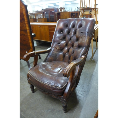 106 - A Victorian style mahogany and brown leather buttonback open armchair