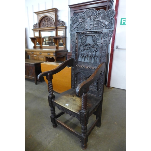 110 - A 17th Century style oak Wainsot chair, with extensive commemorative carving of William III victory ... 