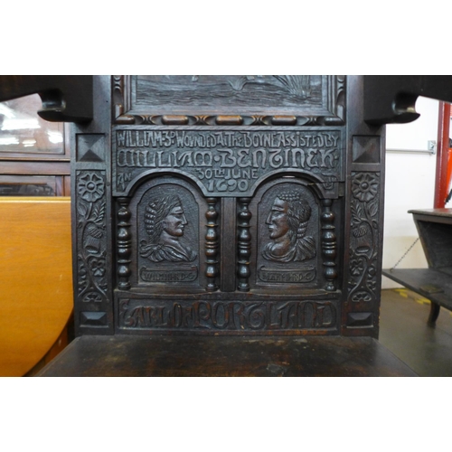 110 - A 17th Century style oak Wainsot chair, with extensive commemorative carving of William III victory ... 