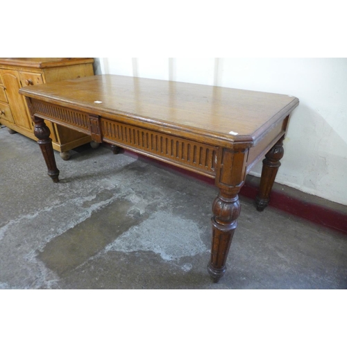 176 - A Victorian oak two drawer library table