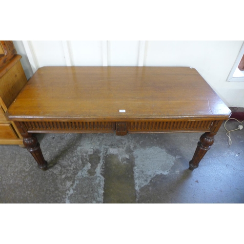 176 - A Victorian oak two drawer library table