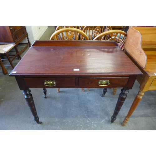 179 - A late Victorian mahogany two drawer writing table