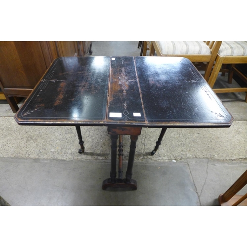 242 - A Victorian Aesthetic Movement ebonised Sutherland table