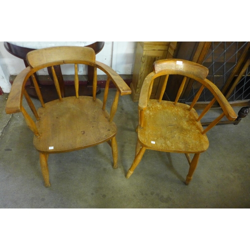 254 - A pair of similar elm and beech smokers bow chairs