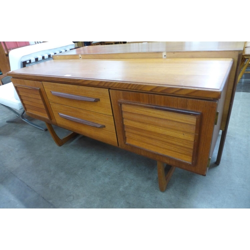 33 - A teak and afromosia sideboard