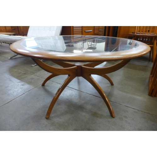 36 - A G-Plan Astro teak and glass topped circular spider coffee table