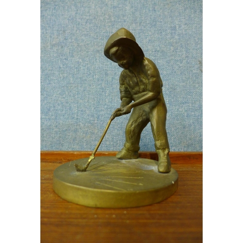 387 - A small bronze figure of a golfer