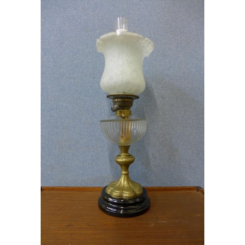 399 - A Victorian brass oil lamp, with clear glass reservoir and double wick burner