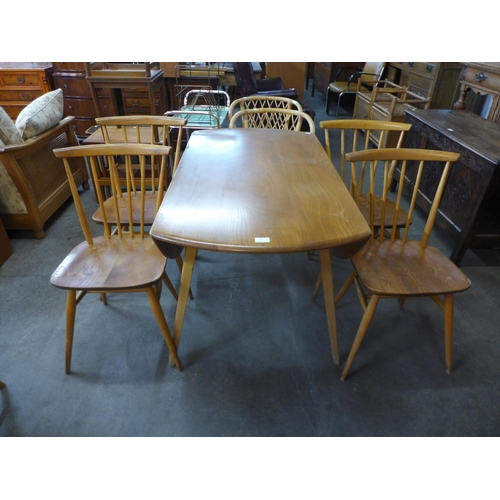 60 - An Ercol Blonde elm and beech drop leaf table and a set of four 737 model chairs