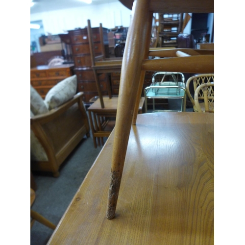 60 - An Ercol Blonde elm and beech drop leaf table and a set of four 737 model chairs