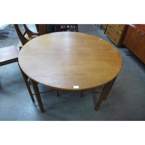 7 - A McIntosh teak circular extending dining table and four chairs