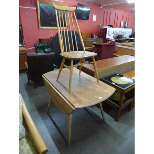 72 - An Ercol Blonde elm and beech drop-leaf table and a Goldsmith chair